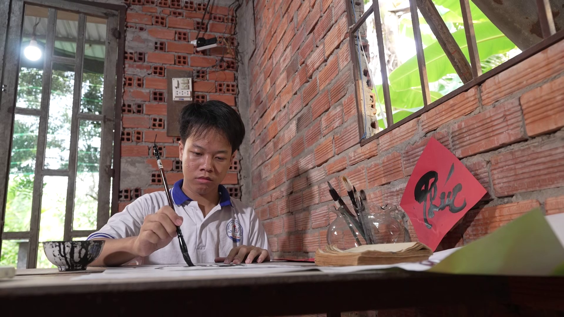 Thư pháp không chỉ là sở thích mà còn là động lực để Ngọc Tiến vững bước đến trường